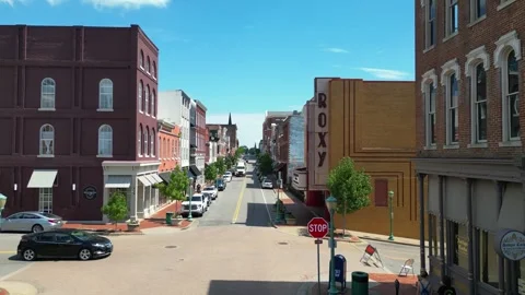 Flying street level toward the Roxy Theater located on Franklin Street in 스톡 동영상 252112530
