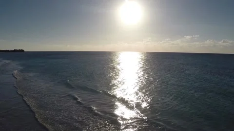 Flying into the sunrise with reflections into the ocean Stock Footage 48000350