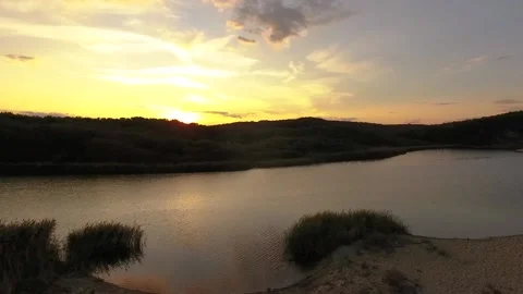 Flying sunset over the river, beach and sea 2 Stock Footage 169050236