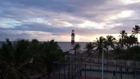 Flying by on sunset sky in beach of the Itapuã lighthouse Stock Footage 301373932