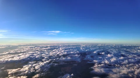 Flying at Supersonic Speed Over an Endless Layer of Stratus Clouds at Sunset Stock Footage 345366089