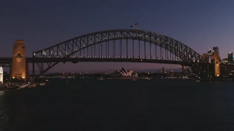 Flying to Sydney Harbor bridge at night with lights on - Drone Aerial Stock Footage 235246847