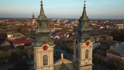Flying through 2 towers of beautiful cathedral of St Teresa Avila in Subotica Stock Footage 166011423