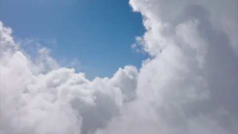 Flying through amazingly beautiful cloudscape on sunny day with clear blue sky 스톡 동영상 172383949