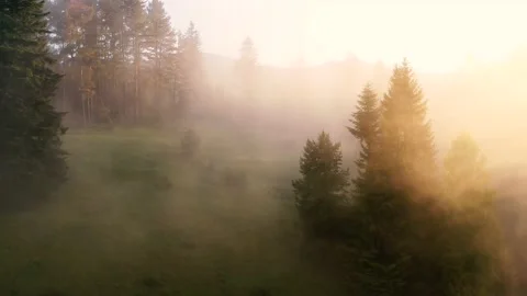 Flying through beautiful sunny clouds over the green mountains. Amazing shot of Stock Footage 137976186