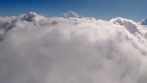 Flying through beautiful thick fluffy clouds. Direct view from the Drone. Video stock 129221143