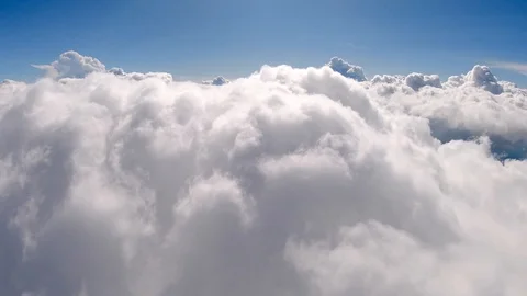 Flying through beautiful thick fluffy clouds. Direct view from the Drone. Video stock 129221256