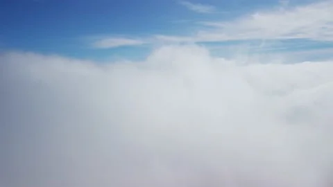 Flying through beautiful thick fluffy clouds. Soft white clouds moving slowly Video stock 221789256
