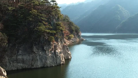 Flying through a beautiful valley over a calm river / Shot on DJI X7 / Super HQ Stockbeeldmateriaal 106048822
