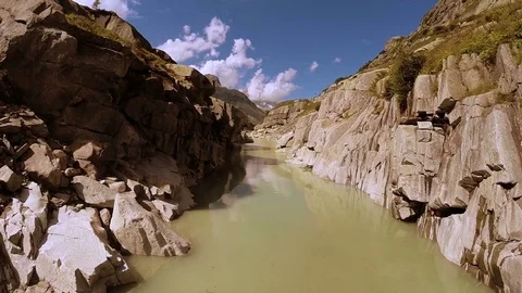 Flying through canyon river in epic mountain rock landscape Video stock 72870296