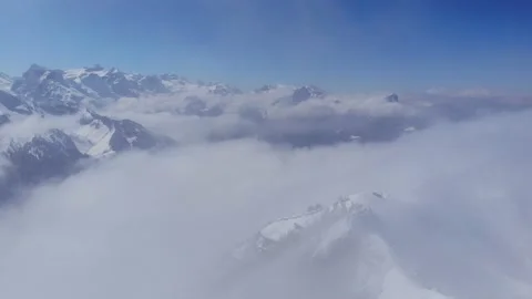 Flying through a cloud above a never ending Swiss mountain range Stock Footage 174930807