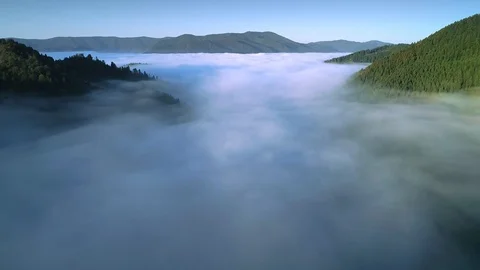 Flying through the clouds above mountain tops. High peaks wonderful morning Vidéo 98314858