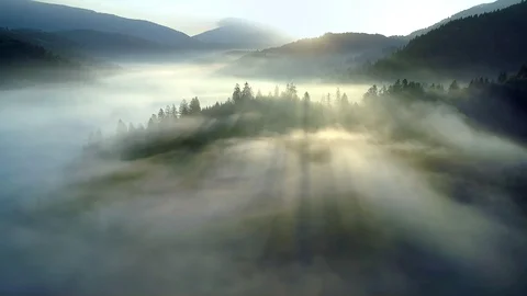 Flying through the clouds above mountain tops. High peaks wonderful morning Stock Footage 98315072