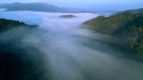 Flying through the clouds above mountain tops. High peaks wonderful morning Stock Footage 99395302