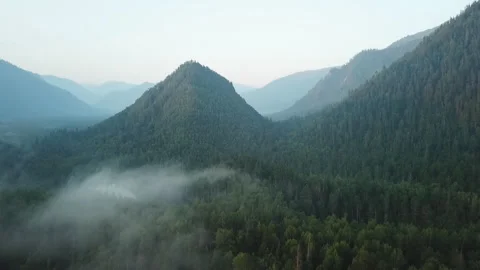 Flying through the clouds above mountain tops. Shooting from the drone. Stock Footage 107902090