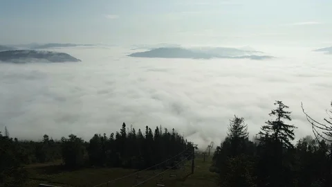 Flying through the clouds above mountain tops. High peaks wonderful morning Stock Footage 112925436