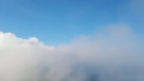 Flying through the clouds above mountain tops Stock Footage 119229545