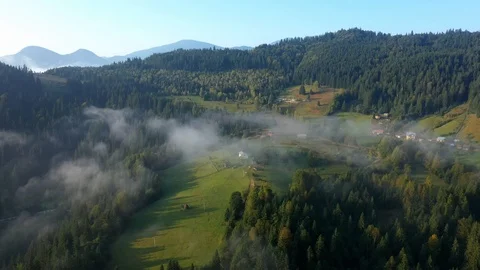 Flying through the clouds above mountain tops. High peaks wonderful morning sunr Stock Footage 121303154