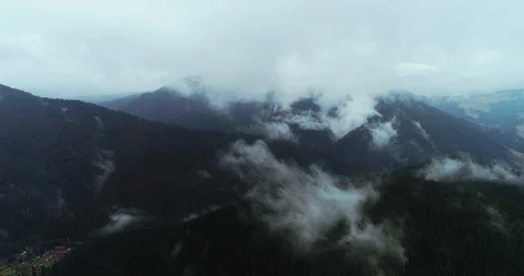 Flying through the clouds above mountain tops. Stock Footage 128697799