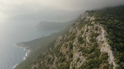 Flying through the clouds above mountain tops. Mediterranian sea. Stock Footage 133081580