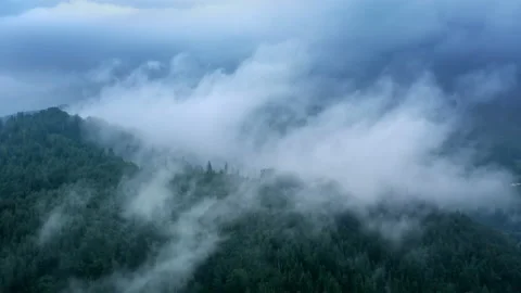 Flying through the clouds above mountain tops. High peaks wonderful morning Stock Footage 135169942