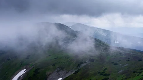Flying through the clouds above mountain tops. High peaks wonderful dramatic Stock Footage 135322915