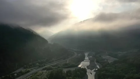 Flying through the clouds above mountain tops. High peaks wonderful morning Vidéo 145575584
