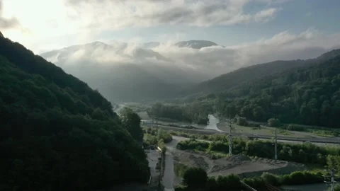 Flying through clouds above mountain tops. High peaks wonderful morning sunrise Vidéo 145575617