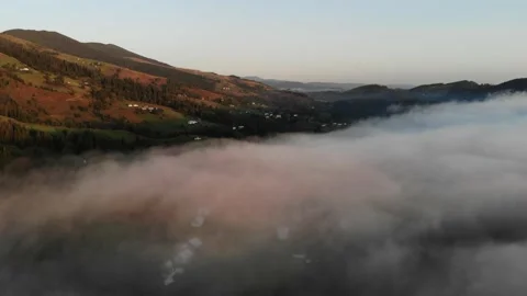 Flying through the clouds above mountain tops. High peaks wonderful morning  Stock Footage 169105480