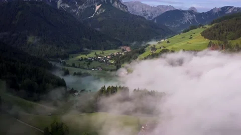Flying through the clouds above mountain tops. High peaks wonderful morning Stock Footage 169369411