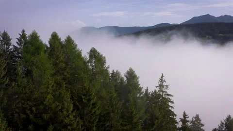 Flying through the clouds above mountain tops. High peaks morning wonderful Stock Footage 169369475