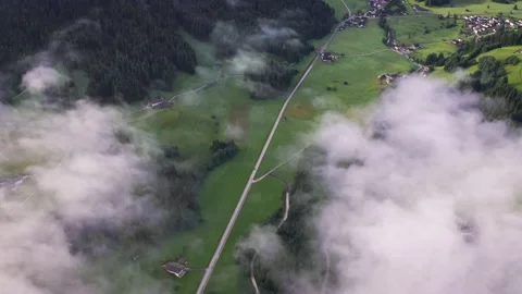 Flying through the clouds above mountain tops. High peaks morning wonderful Stock Footage 169369653