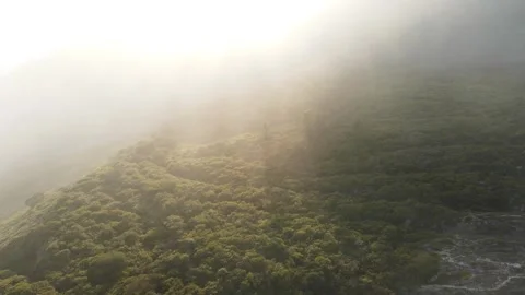 Flying through clouds above mountain tops. High peaks wonderful morning sunrise Stock Footage 285818034