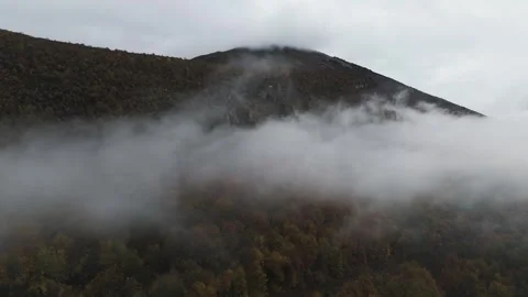Flying Through Clouds Above Mountain Forest Long Shot Stock Footage 321817710