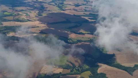 Flying through clouds above Paraná, Brazil, an aerial window view reveals Stock Footage 340830330