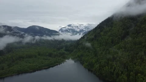Flying Through the Clouds and Mountains on an Atmospheric Morning Stock Footage 196121072
