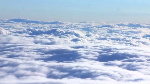 Flying through clouds. Beautiful blue clouds from plane view Stock Footage