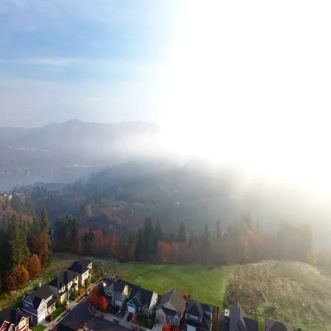 Flying up through the clouds on a beautiful fall day. Stock Footage 69364356