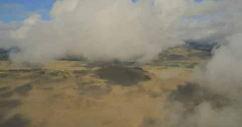 Flying through clouds with beautiful landscape view over the mountains. Stock Footage 62221504