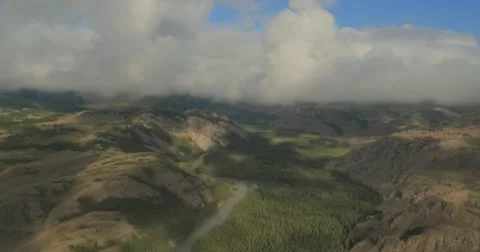 Flying through clouds with beautiful landscape view over the mountains. Stock Footage 62230525