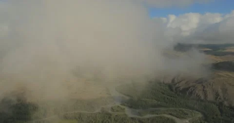 Flying through clouds with beautiful landscape view over the mountains. Stock Footage 62231389