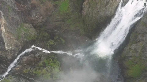 Flying up through clouds from the beautiful Voringsfossen Waterfall, Norway Stock Footage 114066596