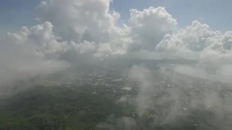 Flying through the clouds, below the forest, villages among the forests Stock Footage 131340989