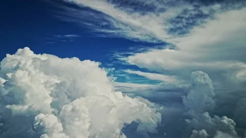Flying through the clouds - Deep blue sky large cumulus clouds Stock Footage 157716580