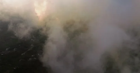 Flying through clouds during sunset light over Munduk village in Bali 库存影片 248755103