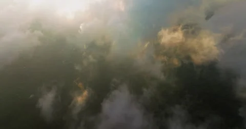Flying through clouds during sunset light over Munduk village in Bali Stock Footage 248902123