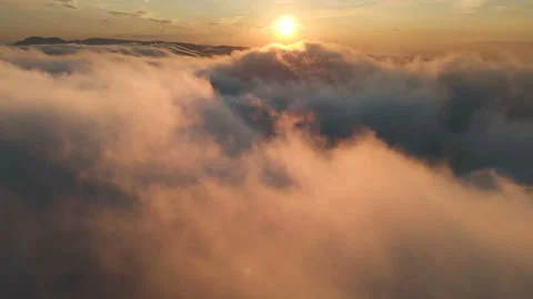 Flying through the clouds at dusk or dawn. Flying in pink clouds in the sun Stock Footage 96632971