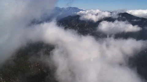 Flying through clouds over the Angeles National Forest in the rugged San Gabriel Stock Footage 59113851