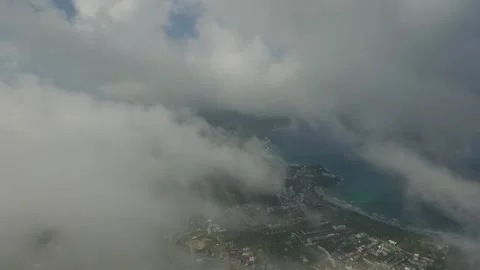 Flying through the clouds over a city on the sea coast Stock Footage 131340951