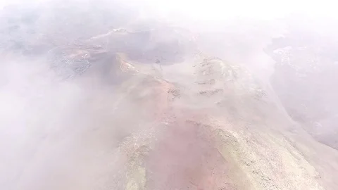 Flying through the clouds over an extinct volcano. Red Earth Stock Footage 73127118
